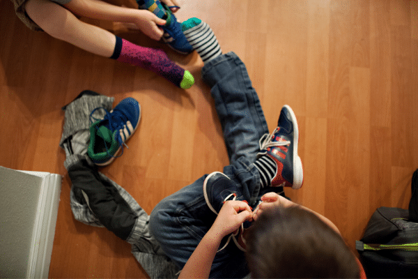 Children putting on shoes