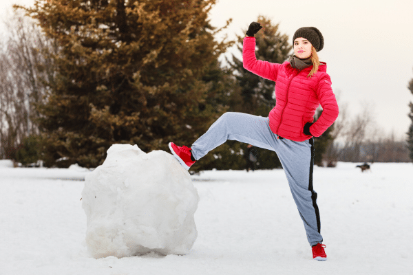 A woman conquering a large snowball