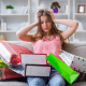 girl on couch upset with shopping bags