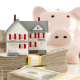 Mini house, stack of money and piggy bank