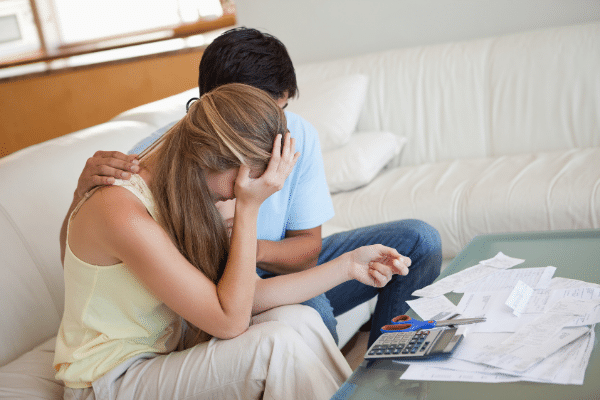 couple looking at finances and upset