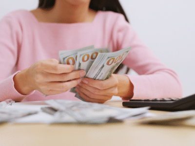 woman in pink shirt counting money