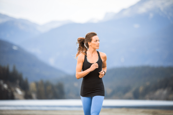 woman running outside.  Black shirt, brown hair