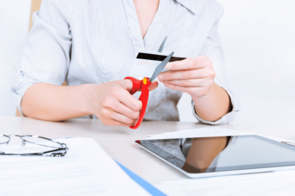 woman cutting up credit card