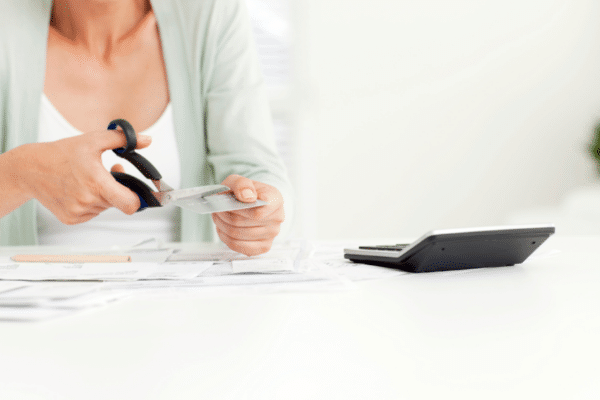 woman cutting up credit card