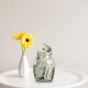 jar of money on table flower in vase