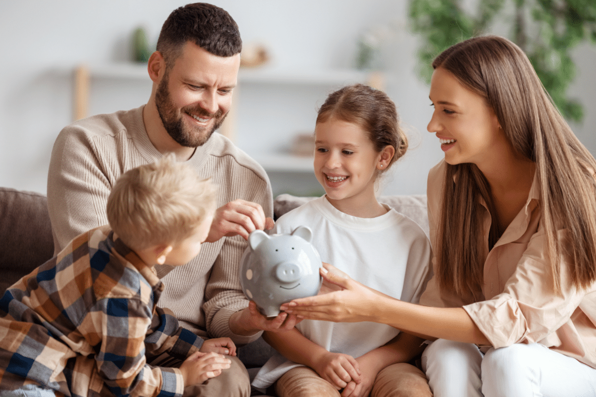 family adding money to piggy bank