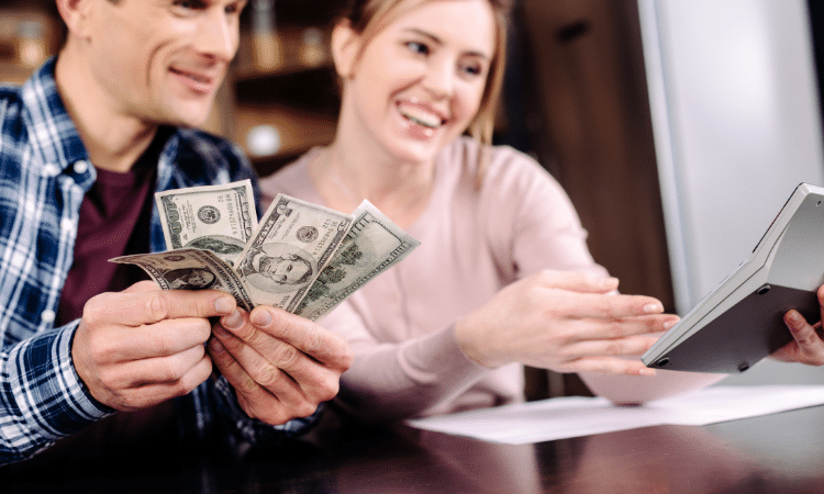 couple smiling with cash