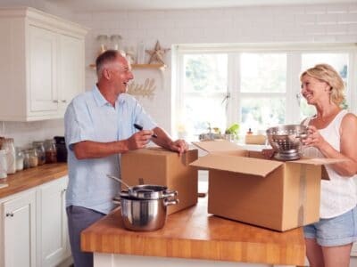 couple packing up their kitchen to downsize