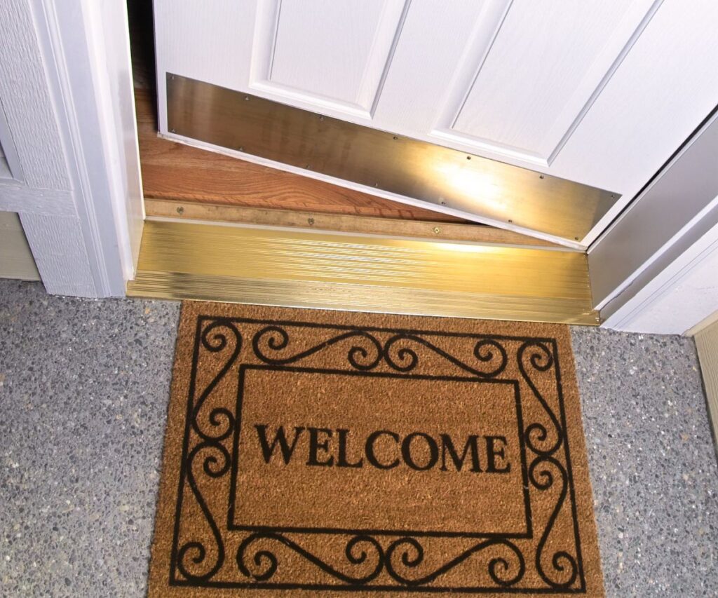 new welcome mat by white front door