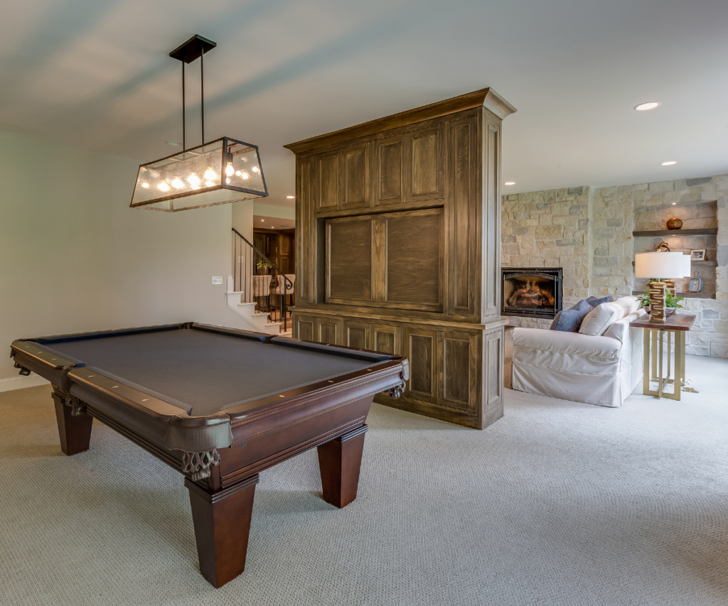 A basement with a large sideboard used as a divider