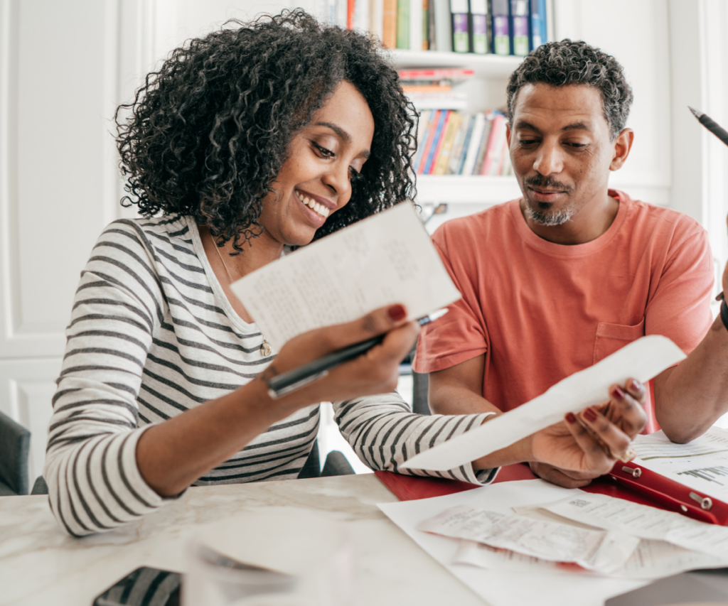 A couple going through financial papers sitting at a table