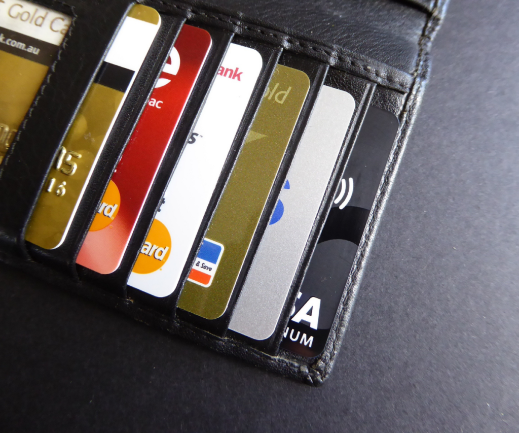 A set of debit cards in a wallet showing just the edges