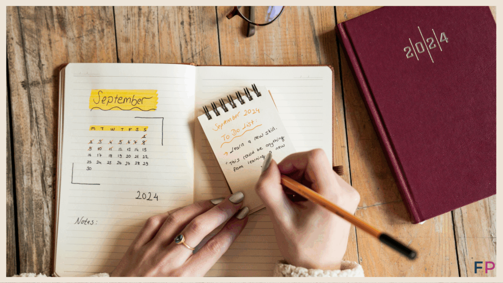Woman writing a list with a diary on the desk