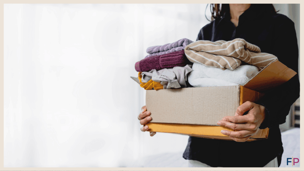 Woman with a box of things to donate as part of decluttering