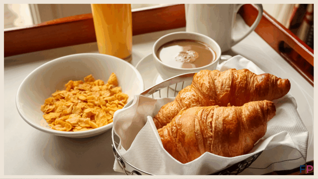 Croissant cereal and coffee on a breakfast tray